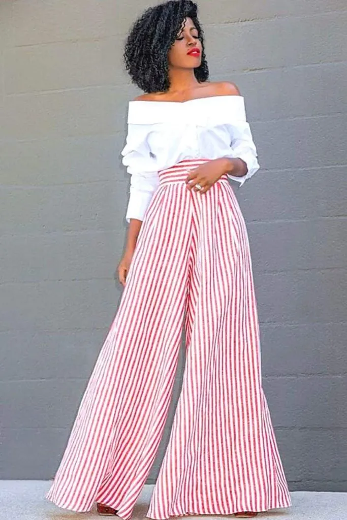 Off-shoulder top and striped pants wedding guest outfit ideas with pants