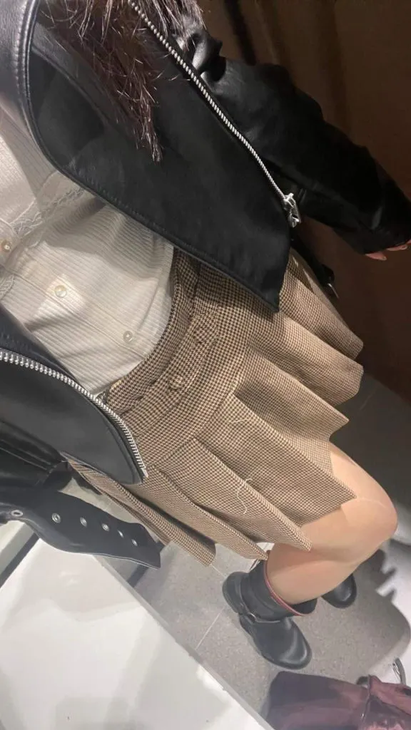 leather jacket and pleated skirt outfit