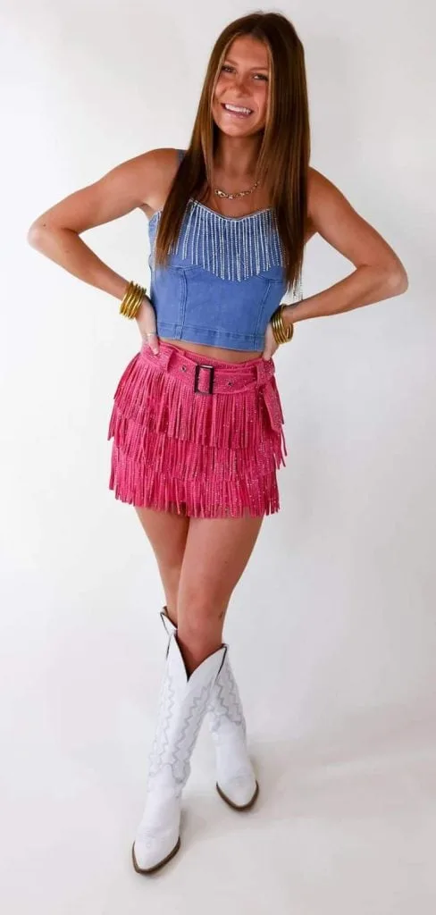 pink tassel skirt and white boots