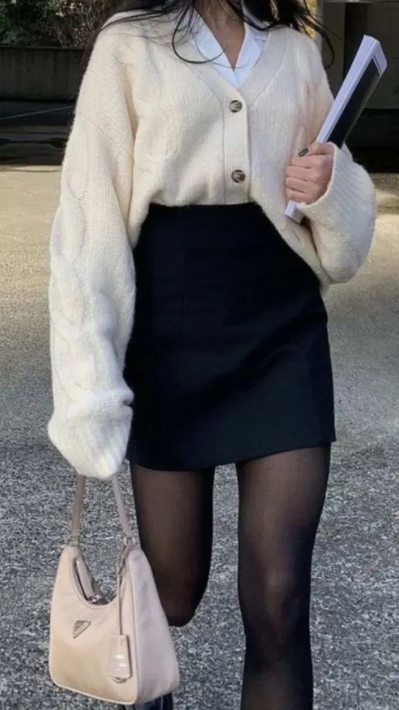 Tuck the cardigan with the jeans