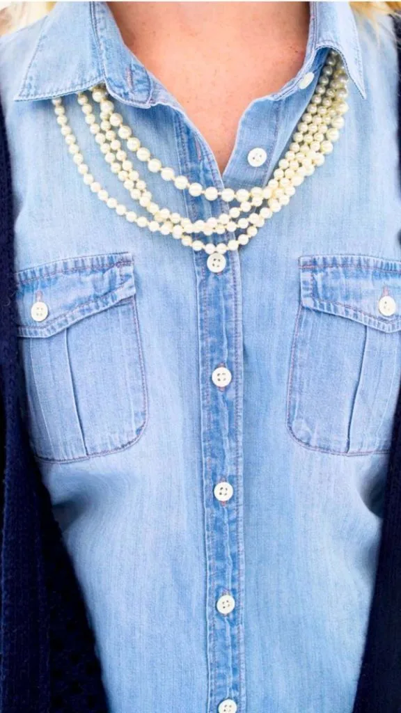 pearl necklace and denim shirt