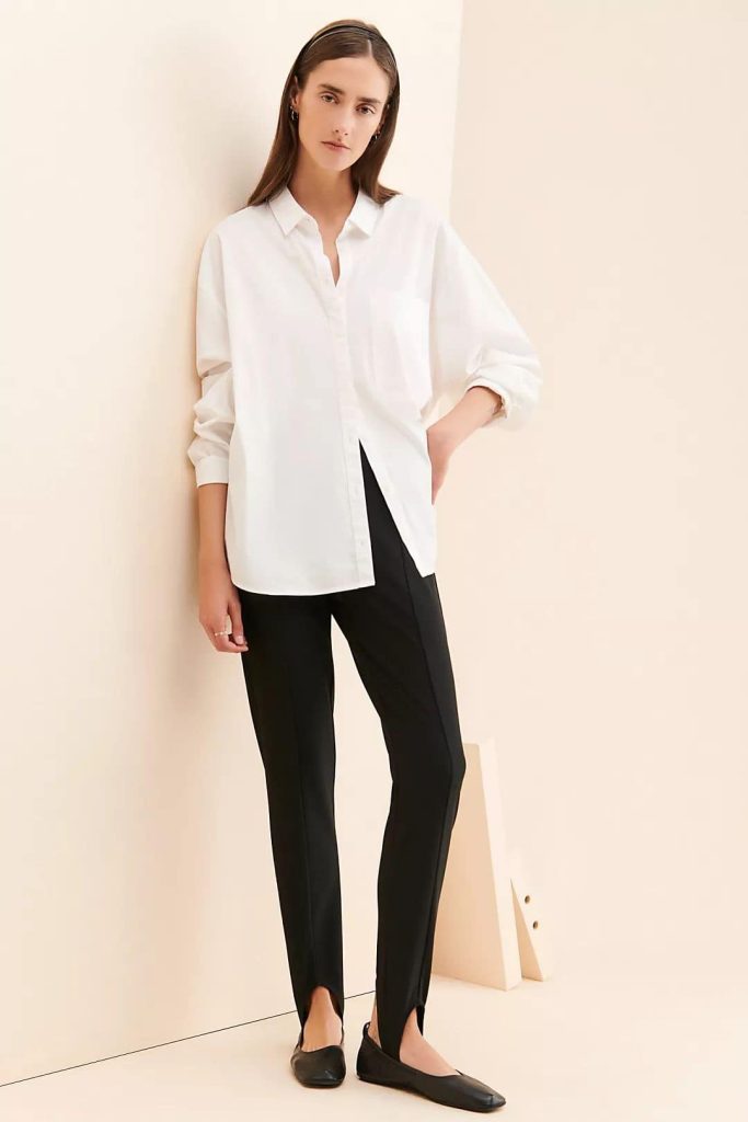 white shirt and black stirrup pants outfit